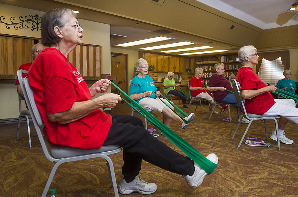 group of senior residents using exercise bands