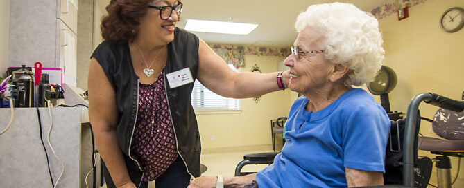 professional hair stylist cutting a senior women's hair in the resident salon