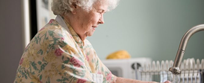 Older woman washing produce