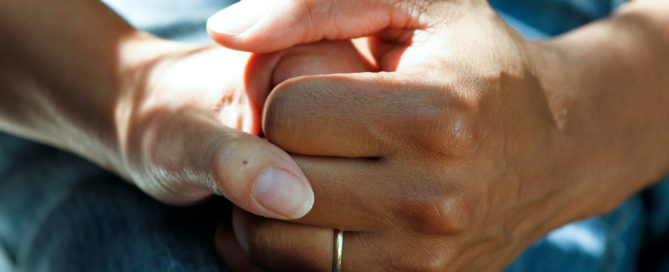 Older couple holding hands