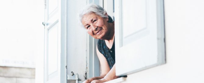 Older woman looking out of a window