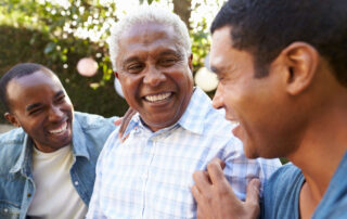 Senior father and two sons smiling