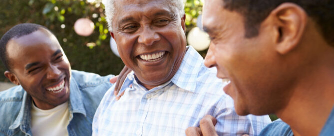 Senior father and two sons smiling