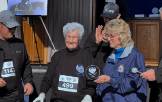 Resident Wilma receiving her marathon award