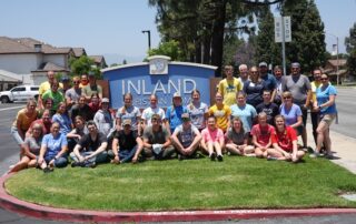 TASC team group photo in front of the large Inland Christian Home sign