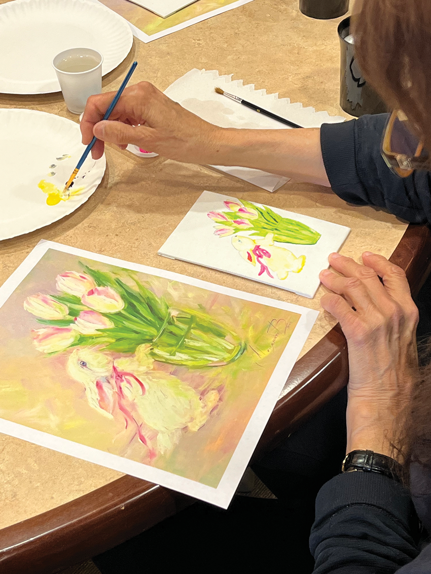 Senior painting a rabbit and tulips