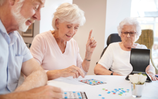 Senior playing games at table