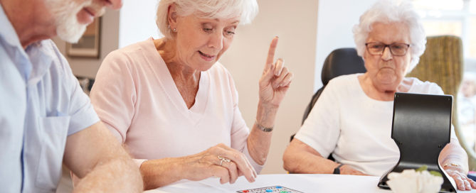 Senior playing games at table