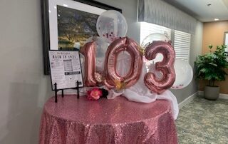 balloons depicting 103 for resident birthday party