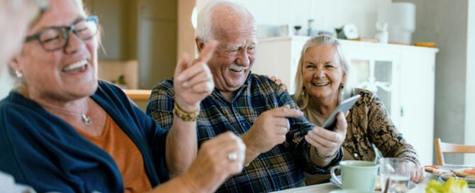 seniors eating a meal and laughing as friends